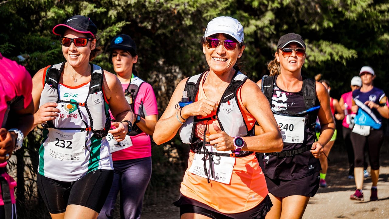 Trail runners on a mountain course, watches on their wrists